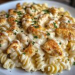 cheesy alfredo twisted pasta with golden garlic butter chicken in creamy sauce